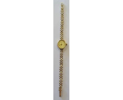 A ladies Rotary quartz Wristwatch with oval champagne dial, baton numerals in gold case and on a gold strap.  (9.9gms gross)