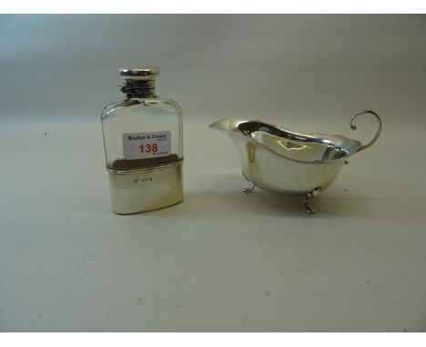 A glass Hip Flask with silver cup and cover, London 1913, maker: Drew & Sons, and a silver Sauce Boat with crimped rim.