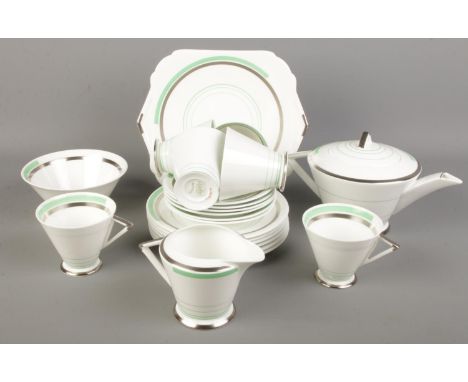 An Art Deco Shelley tea service. Decorated with green and silvered borders.  Sugar bowl cracked.
