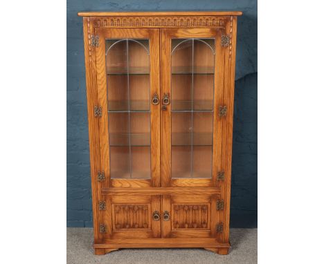 A Priory style carved light oak lead glazed display cabinet. (153cm x 91cm)  