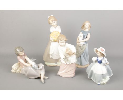 Five Nao by Lladro figures. Including large girl with pumpkins, girl with cat, girl with rabbit, etc.  