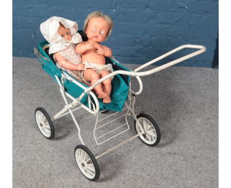 A vintage pram along with two dolls.  