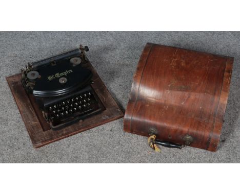 A cased The Empire typewriter.  