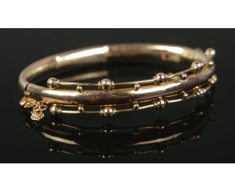 A Victorian yellow metal hinged bangle, with inscription to the inside of the band, dated 1890. Total weight: 7.95g.  