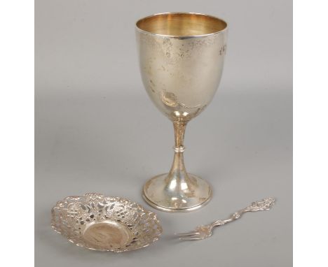 A silver goblet along with a white metal pierced dish and a Swedish silver fork.  