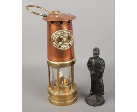 A E.Thomas &amp; Williams Ltd Cambrian copper and brass miners lamp along with a Kingmaker coal figure of a miner.  Miners la