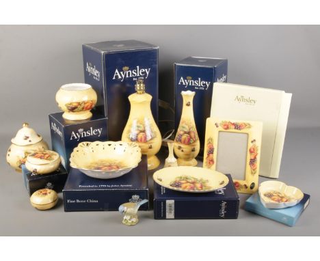 A quantity of mostly boxed Aynsley Orchard Gold ceramics. Including table lamp, photo frame, vase, leaf dish, etc.  