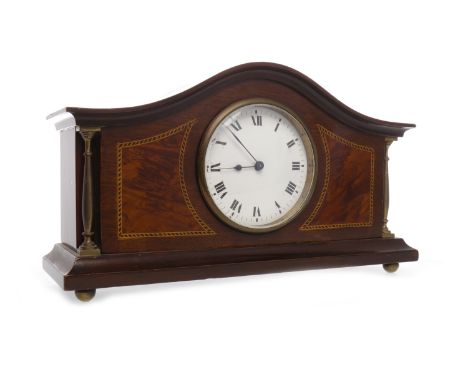 EDWARDIAN MAHOGANY MANTEL CLOCKthe French movement unnumbered, the white enamel dial with Roman numerals, contained in an arc