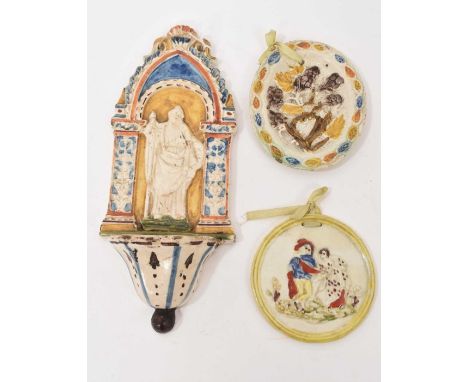 Prattware moulded plaque, circa 1790, decorated with berries, together with a pearlware plaque and a creamware holy water sto