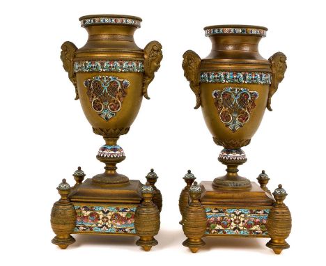 Two 19th century French brass and champlevé enamel urns, each of baluster form on square base and toupee feet, 27cm high