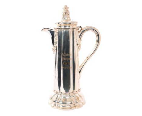Large Victorian electro-plated communion flagon of fluted tapering form, with reeded loop handle and hinged flower head mount