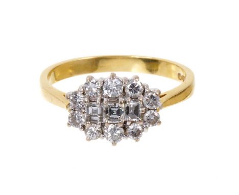 Diamond cluster ring with three square step cut diamonds surrounded by a border of eight brilliant cut diamonds in claw setti