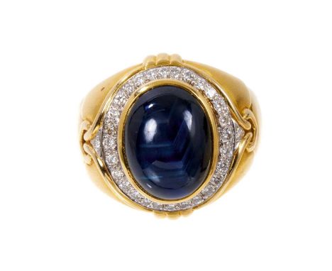 Sapphire and diamond ring with a large cabochon blue star sapphire measuring approximately 14.5 x 11mm surrounded by a border