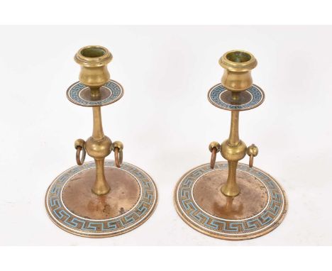 Pair of 19th century Greek revival candlesticks with blue and white enamel Greek key borders and central twin ring handles, 1