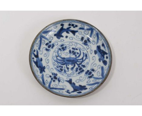 Chinese blue and white dish, Kangxi period, decorated with a crab and fish, brown rim with celadon glazed back, marked to bas