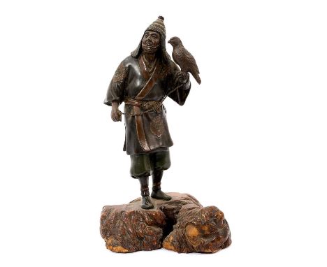 Japanese Meiji period bronze figure of a falconer, finely modelled in patinated and mixed metals, raised on a root wood base,