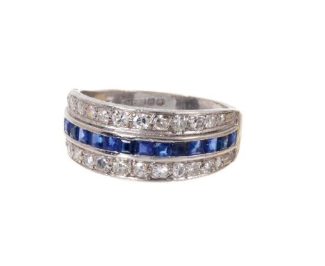 Sapphire and diamond eternity ring with a central band of calibre cut blue sapphires flanked by two rows of single cut diamon