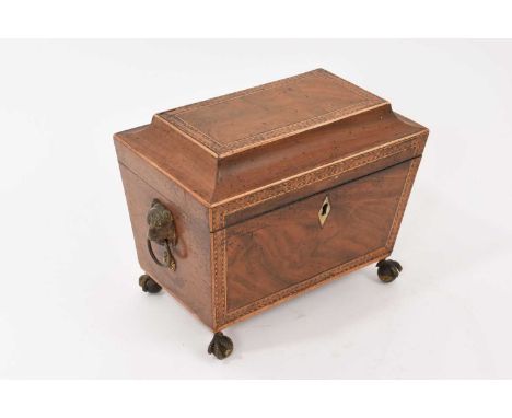 19th century mahogany and parquetry two division tea caddy, of tapered sarcophagus form with flanking lion mask drop handles,
