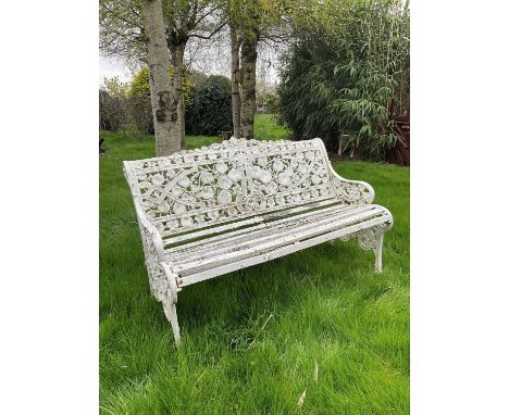 Victorian style white painted cast metal garden bench with lily pad and foliate design, 131cm wide.