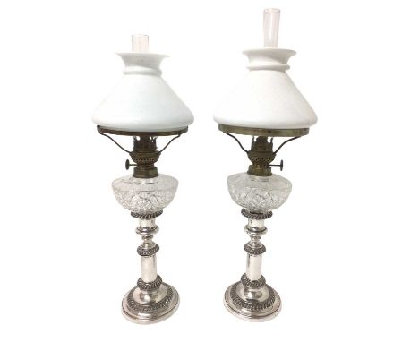 Pair of Victorian plated telescopic peg lamps, each with milk glass shade and cut glass reservoir on plated candlestick base,