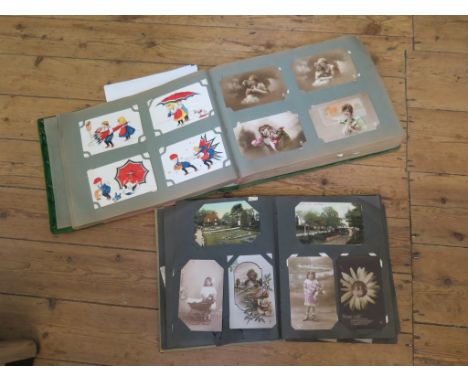 Two albums of World War One postcards, one album inscribed 'To Dear Winnie from her daddy who is at Calais in France received