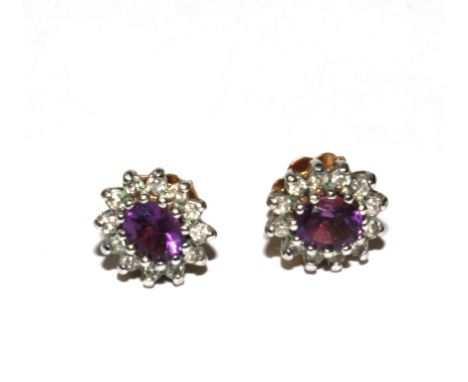 A pair of diamond and amethyst earrings