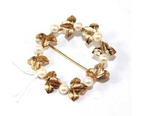 A gold and pearl set brooch