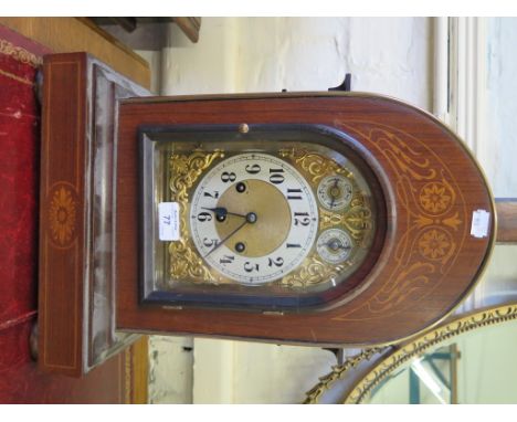 An Edwardian inlaid mahogany bracket clock, the arched cased enclosing a brass dial with silvered chapter, speed and strike/s