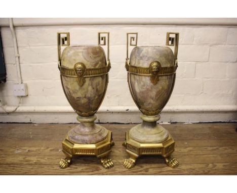 A pair of large gilt metal and marble garniture vases, of Regency style, the turned marble vases with metal mask and scale ba