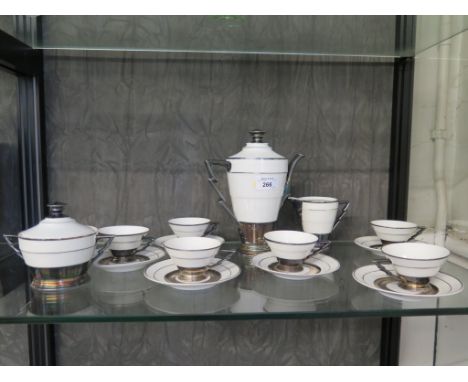 An Art Deco style porcelain coffee service of stepped corical form with silver highlights, six cups and saucers, coffee pot, 