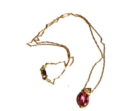 An 18 carat gold pendant set with a pink stone (possibly tourmaline) on 18 carat gold neck chain