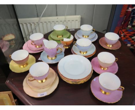 A set of ten polychrome cups, saucers and plates with gilt highlights and initialled on the bases A.M.R., and various other s