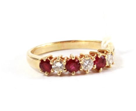 A six stone ruby and diamond ring set in 14 carat gold