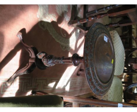 A mid Victorian carved walnut tripod table, the circular top over a carved baluster stem on cabriole legs