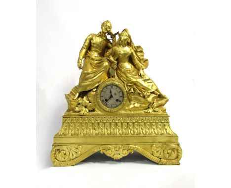A large early 19th Century French ormolu/gilt metal mantel clock, the ornately designed floral and scroll style base surmount