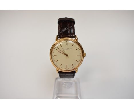 IWC: An 18k gold cased IWC (International Watch Company) gentleman's wristwatch, the baton marker dial with centre seconds, o