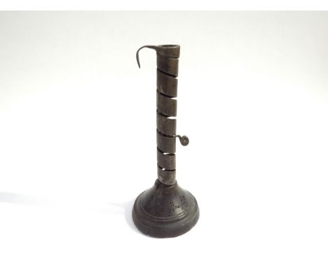 An 18th Century iron spiral twist candleholder on a fruitwood base