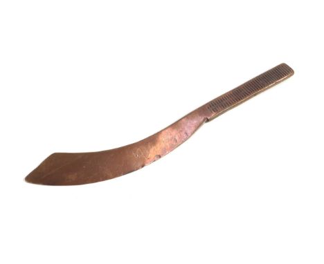 A Great War (1914-18) trench art letter opener, made from a section of artillery shell copper driving band, hammered into sha
