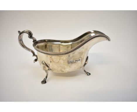 An R F Mosley and Co silver sauce /gravy boat s-scroll handle, hoof feet, facet body, Sheffield 1936, 9.5cm tall x 19cm long,