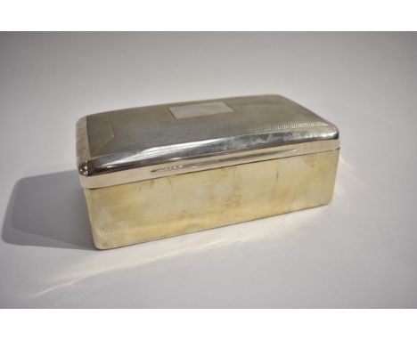 A Charles Stuart Harris silver cigarette box with engine turned detail, vacant cartouche. Lined wood interior London 1900, 6.