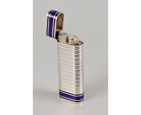 A fine silver and enamelled cigarette lighter from Cartier, the oval elongated body with ribbed centre and having black and p