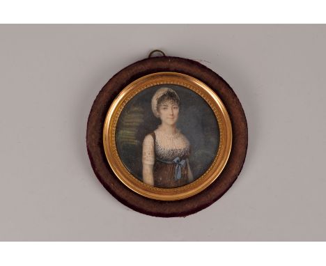 A Georgian period English School portrait miniature, the circular panel, possibly ivory, having well painted half portrait of