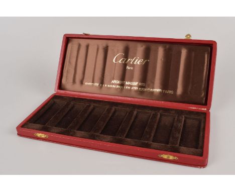 A “Day of the Week” cigarette lighter box from Cartier, the red leatherette case with seven divisions for each lighter, marke