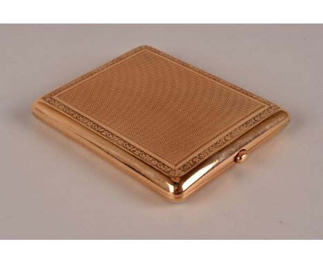 A George V period 9ct gold compact by Goldsmiths & Silversmiths, rectangular with engine turned panels and scrolling foliage 
