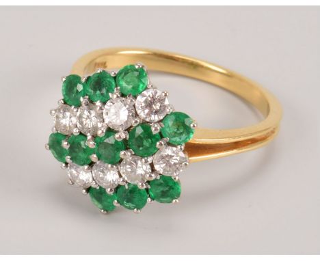 A vintage emerald and diamond dress ring, the hexagonal shaped tablet set with rows of round cut green stones and brilliant c