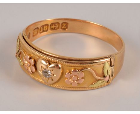 A late Victorian 18ct gold and diamond “Dearest” ring, having a hinged tablet with two flowers and an old cut in heart shaped