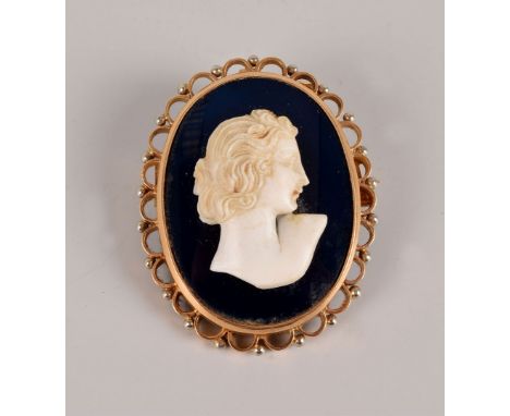 A pretty Art Deco period cameo brooch, the blue glass oval panel having a carved bust of a lady in a yellow metal mount, prob