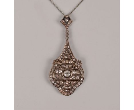 A fine Belle Epoque platinum and diamond pendant, the large tear drop style shaped pierced mount with three flower heads and 