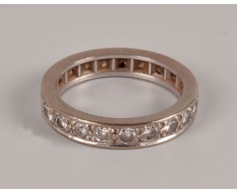 A vintage white metal and diamond full eternity ring, the probably platinum band set with brilliant cuts, four chipped, appro