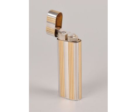 A fine silver and 18ct gold cigarette lighter from Cartier, having banded gold inlay marked 750 to silver oval elongated body